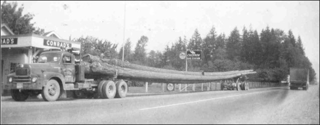 (Log truck at Conrad's service station)