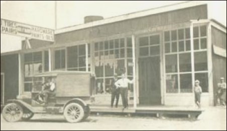 (Slipper delivery truck in front of store)